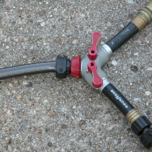 Flushing setup for use with twin HONDAs. Individual red control handles allow uniform water flow thru each engine as needed.