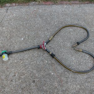 Flushing setup for use with twin HONDAs saves 20 minutes by doing both engines at once. Parts available at many hardware stores. The two adaptors on the end of the twin hoses are custom HONDA fittings. The Plastic white container is for the "SALT AWAY".