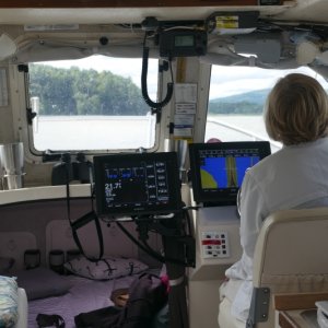 Taking turns in the helm and nav seat.  VHF transmitting (but not listening) requires a FCC radio telephone op permit for outside US including Canada and Bahamas.