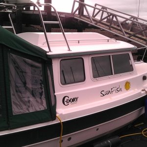 Custom Hi top Bimini w zipper for easy entry at bulkhead. Hi radar arch for stowing dinghy.