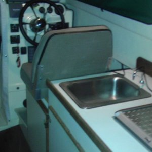 Starboard Helm, Flip forward Helm Chair, Stainless sink, Wallas Ceramic two burner stove top,