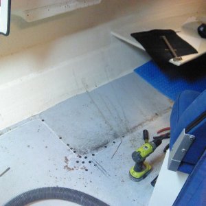 Once the port side seat box was removed, I could tell that there was a substantial problem.  You can see a white line of caulk that kept water (and dirt) up against the pop rivets.  I'm not sure what the little strip of caulking was intended to do.