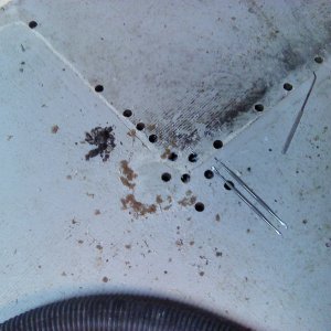 I drilled out the mounting holes where the failed pop rivets had been and started drilling radiating holes to determine the extent of the damage.
