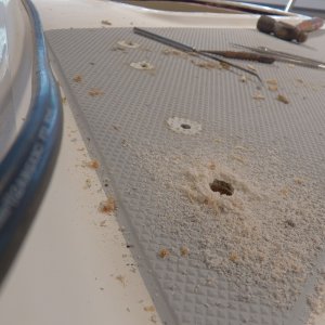 I drilled them out oversized so that they could be filled with epoxy putty for a proper deck mounting.  The swarf looks good, but it was soaking wet.