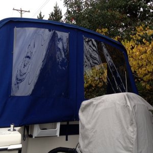 Back window port side has snap on cover, snaps on bows inside will take shower curtain for potty privacy