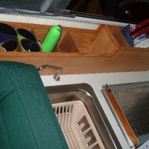 Storage compartment behind stove