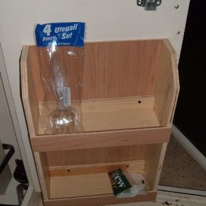 storage comparment on door below stove