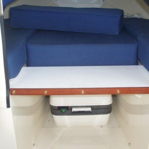 1x11x23-inch PVC board (scrap) notched to span v-berth opening.  Trim is scrap wood teak oiled,  glued and screwed in place (14DEC09)