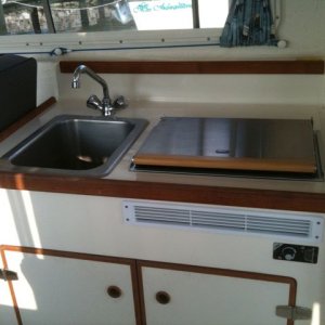 The galley area, showing sink and Wallas heater/stove