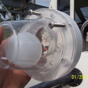 The scupper has a rectangle hole in it that goes down and the gasket that goes between the scupper and the spacer has a hole in it that the ball seats in and that hole goes up.