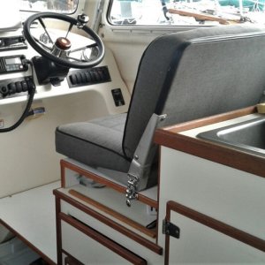 Raised helm seat for more storage and better view.  It is removable with 2 lock downs to provide extra counter space.  Removable helm foot rest give additional storage as well.