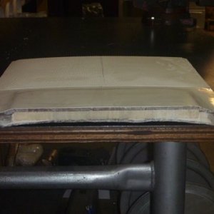 Roof piece shows two different core materials,notice grey stuff to the right and left of the center material.The top or the part which is outside in the weather looks to have about 3/16 worth of fiberglass while the inside or bottom side only has about 1/8 inch fiberglass