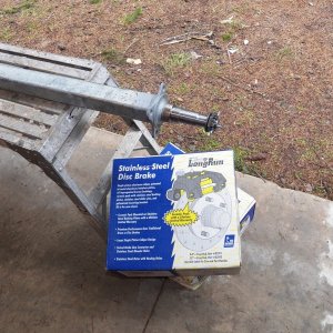 The new axle and brakes.  Brakes came three days after ordering.  Axle took 2 months.  This is a 3.5K# axle, the smallest that comes with brake flanges.  I didn't need 3.5K# for a CD 16, but I did need the brake flanges.  Turns out that getting a new axle is the simplest way.