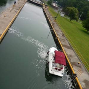 P1000464 It's customary (say the lock tenders) to leave a can of unopened beer as a token or your gratitude on the wall at this point or when in previous chamber when it's at the full point, wine is also acceptable. Hard to reach top of the wall when water is at the low point