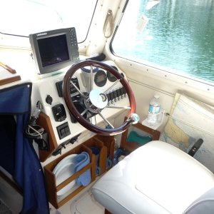 22. Dish and cup storage.
The teak to the left of the helm and above the dish rack is to hold the "www.RAM-MOUNT.COM" laptop computor bracket. You can sort of make out a part of the black "RAM" computor bracket and the "Lorrance" GPS plugin for the laptop. We use "Nobletec" Software for navigation when exploring higher up the British Columbia Coast.