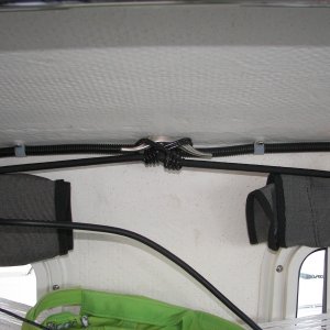 Shock cords on small cleats over windows allow you to hang things, tie up the forward fenders and clip the window covers in varying positions to fit the conditions.