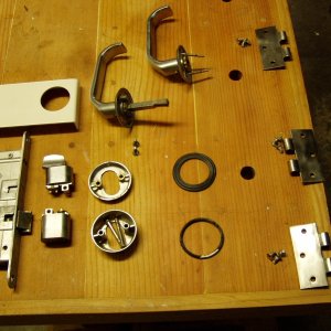 door lock taken apart.  The dead bolt is tricky to get out.  See next picture.