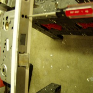 Dead bolt is removed  by loosening two flat blade screws deep inside the lock frame.  Do not remove the screws all the way, just enough to get the dead bolt out.