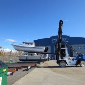 Putting boat on the stand to be washed down.