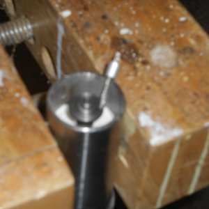 I store the expansion pin, when not in use, in a 1/4" hole drilled into a Starboard plug glued into the top of the lower mast.