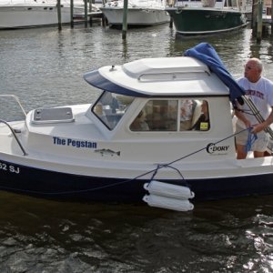 Merv aboard The Pegstan arriving at Caribbean Jacks