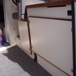 New style doors with teak trim and replacement of the ice box with door and shelf.