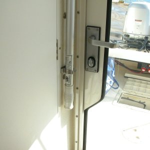 Plenty of clearence between boat hook and door handle when door is closed. Aft deck hatch is open to air out bildge after cleaning pump strainer.