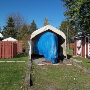21/10/2011..all bundled up for the winter.. its to cold outside to measure for a custom storage cover this year,will have to wait untill the Spring..i reinforced the garages' tie downs, i hope the wind doesn't blow the shelter down, if it get too windy i will have to take the side and rear panels off.