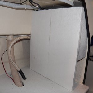 This is my new electrical cover.  It is two pieces of 10" Azek plastic trim glued together.  Cheaper than Starboard.  Hold screws better than SB.  Glues better than SB.  Floats better than SB.  I prefer adding things that float to a boat.