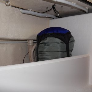Sleeping bag in the cubby.  I'm planning on using the flat panel to mount my flare gun kit and a second fire extinguisher.  The "exposed" wiring that is left is mostly in white conduit and would now be very difficult to snag.