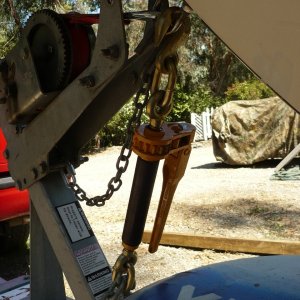 This is working out very well. It is so easy to put on and take off. Fasten the rear tie downs first, then this big guy tigtens both ends down tight (by pulling the front down, back up)and front end tight to both the bow stop and the front keel roller. You can just twist the shaft by hand until tight, then a crank or two on the handle. This is the ultimate turnbuckle. The item I used is called an SCC Quikbinder. I got mine at Tarpstop.com for 34.50 + ship. I'm sure it is avail. elsewhere. WL is 7100#.(35,500# avg. break) I think at that point it is probably stronger than the bow eye. I cut off the bottom hook with an angle grinder (wouldn't want this thing bouncing down the highway) Have gained enough confidence to consider adding the powerwinch 912 back on.