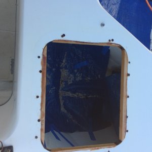 Hatch removed and filling old holes with epoxy, then drilling oversize and filling new holes before drilling for fasteners.  Inside diameter of new hatch frame is smaller, so shims were epoxied in place.