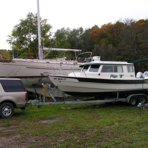 (Stanley-J) Sirena, our Tayana 37 in background prior to hull painting with our new C-Dory 25 "Plan-B".  10/05