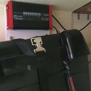 The house battery and charger are under the port seat.