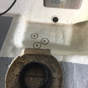 Cutting out the 3 screw holes for the bilge pump mount to screw into solid resin.