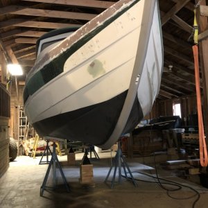 Two layers of Pettit Vivid bottom paint were applied over the primer coats. The original brass keel guard was removed, the screw holes were drilled out and filled with thickened epoxy, then the keel guard was re-installed. The newly applied bottom paint was sanded away where a new 8' KeelGuard would go, and it was installed over the original keel guard.