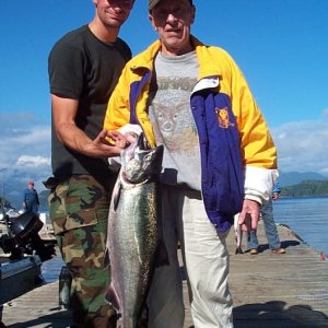 Middle son helping grandpa hold his last fish.