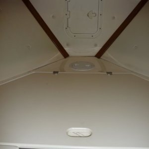 1st - a large forward "V" shaped storage locker. 
2nd - 6" round access hatch to the inside of the stem and under the anchor locker. This hatch gives clear access down under the "V" storage locker and under the cabin sole to the cabin 6" access access hatch at the inside of the door bulkhead.
3rd - Rectangular Hatch cover opens to the anchor locker.