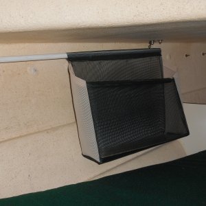 It took about 15 mins for the mate to sew it.  I used dowels, eye screws, SS tabs and a second nut on the through deck bolts to hang it at the foot of the v-berth.