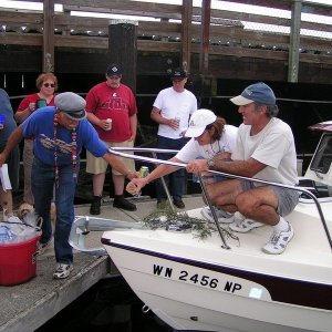 (Pat Anderson) Rev Dave Pours the Elixir on Two Lucky Fish to Appease the Gods