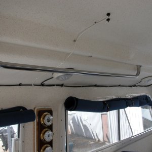 (Sea Angel) Port Side Grab Rail with factory window covers rolled up and held with small bungie cords.
Note WX Station between port windows and variable speed fan above Mate's seat.