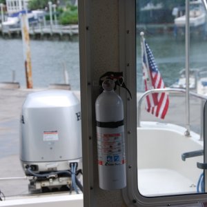 First fire extinguisher - inside cabin door, port side.