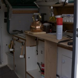 Starboard bed support provides useful counter space for galley. Drop down foot support shown in background