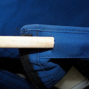 I cut a slit on the inside of the hem on the bottom to fit a piece of dowel.