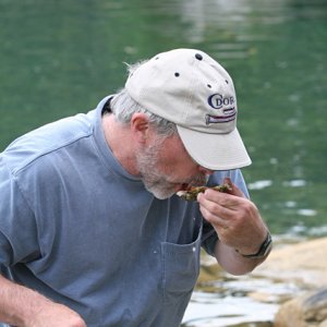 Tom enjoys a steamed oyster.