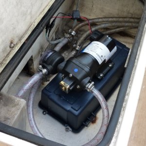 Pump mounted on bottom part of plastic toolbox to raise it 4 inches off bilge