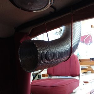 The hose simply extends into the forward cabin by a few inches and is held in place by a bungee cord.   This allows quick assembly/disassembly and also facilitates some directional placement if so desired.  I was amazed by the strength of the air flow, which quickly cooled the area