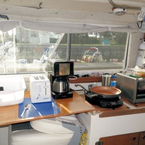 Galley extension over helm seat with 110AC outlet freed up after removing water heater and getting more storage cabinet space