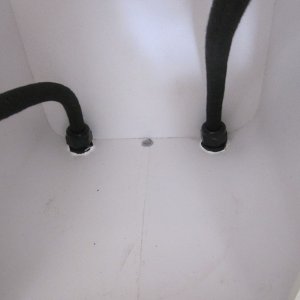 Inside locker showing hoses sealed by bulkhead fittings & drain at bottom