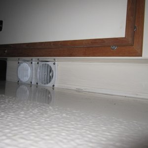 Heater outlets in toe kick under helm seat